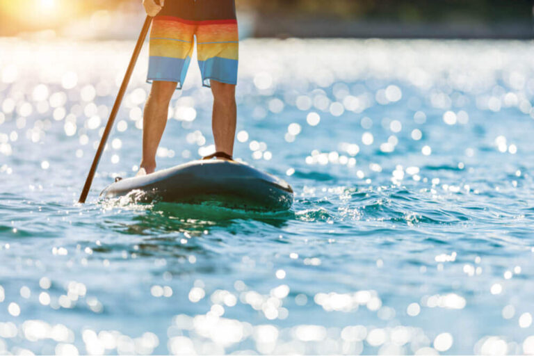 paddleboarding on a lake for summer staycation