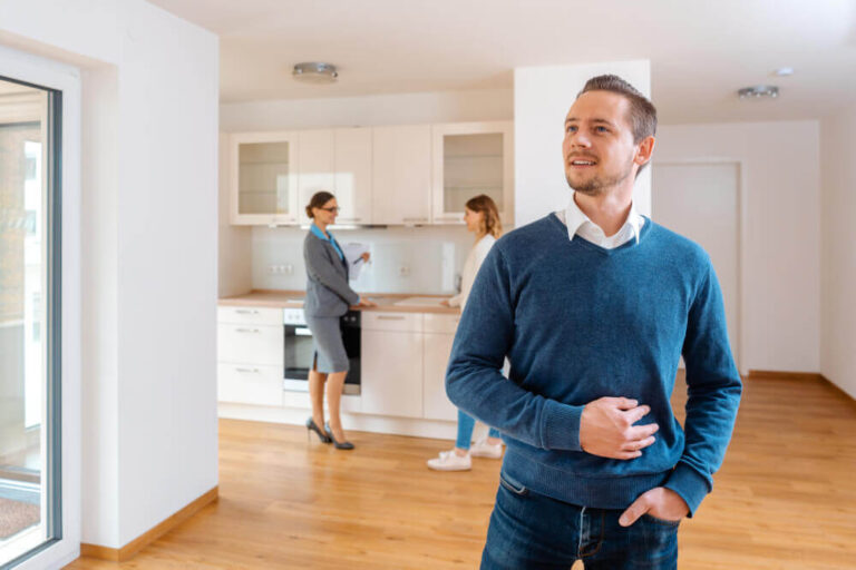 man looking around new apartment