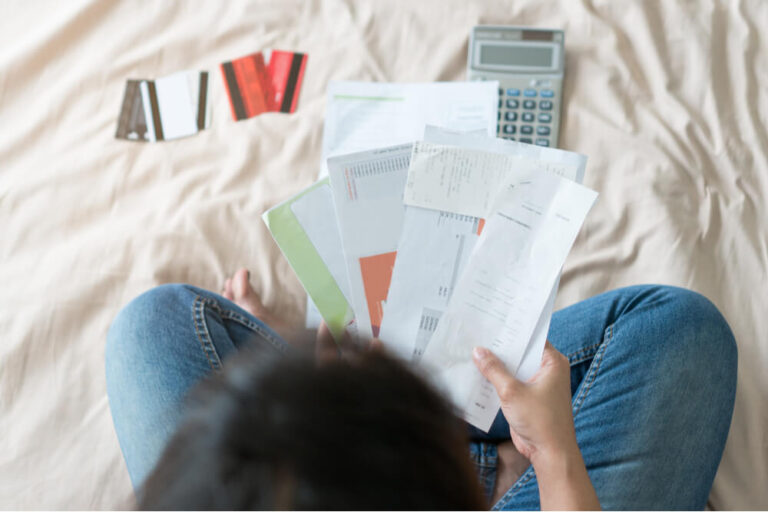 woman going through debt and expense documents